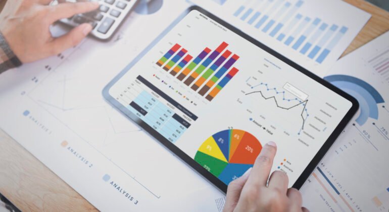 Businesswoman using a tablet to analysis graph company finance strategy statistics success concept and planning for future in office room.