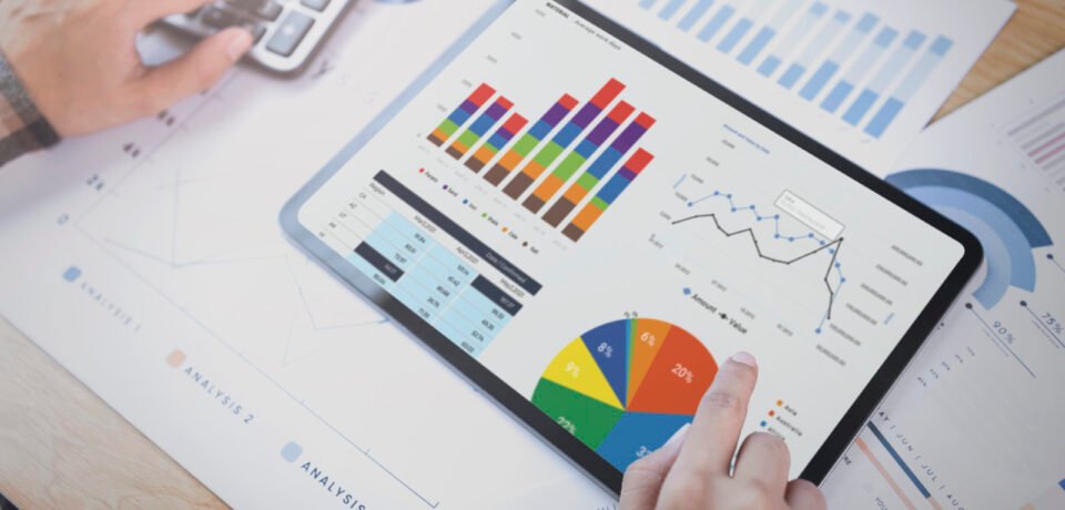 Businesswoman using a tablet to analysis graph company finance s Businesswoman using a tablet to analysis graph company finance strategy statistics success concept and planning for future in office room.